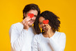 © Prostock-studio - Romantic Interracial Couple Covering Eyes With Red Paper Hearts In Hands