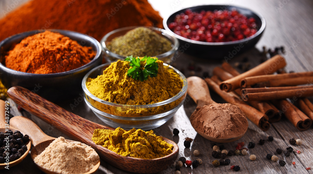 Variety of spices on kitchen table - obrazy, fototapety, plakaty 