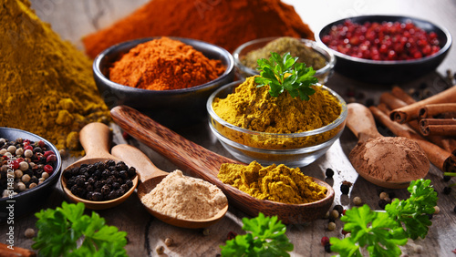 Photo Variety of spices on kitchen table