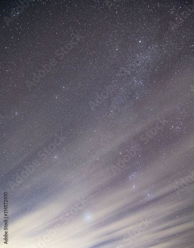 Cuadros en Lienzo orion and sirius in clouds at night. Winter night sky