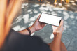 © Farknot Architect - Mockup image of a woman holding black mobile phone with blank desktop screen