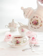 Tea time served with  fine china porcelain set with floral pattern. 