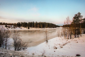 Wall Mural - Landscape with the image of the ice covered frozen river Kem in Karelia, Russia