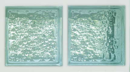 Transparent two green square plaster glass block cube in white background with circle bubble pattern rough texture .Use for object and material. Arrange in double panel and can be link with others.