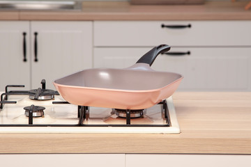 Wall Mural - Purple pan on wooden counter of open plan kitchen