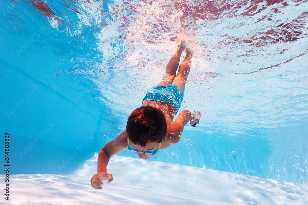 Reaching Bottom Boy dive in the pool reach bottom with hand Stock Photo | Adobe Stock