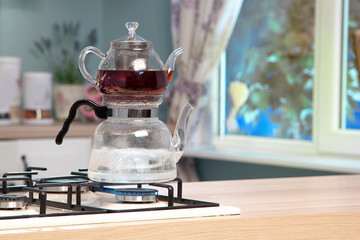 Wall Mural - Glass teapot on wooden counter of open plan kitchen