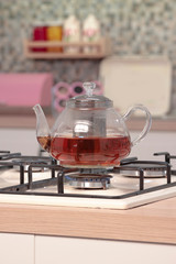 Wall Mural - Glass teapot on wooden counter of open plan kitchen