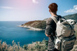 Man tourist with backpack on the mountain see the beautiful nature landscape of the sea