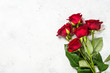 Red roses flower bouquet on white background top view.