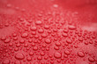© GCapture - Closeup red car paint surface with hydrophobic ceramic coating