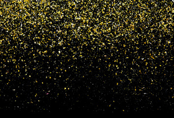 Golden glitter texture on black abstract background