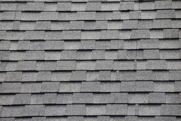 Roof shingles background and texture. grey and black asphalt tile of house roof.