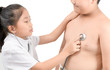 © kwanchaichaiudom - Little doctor check heart by stethoscope to obese boy