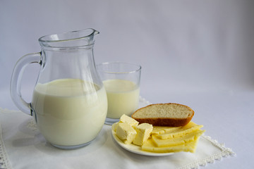 Milk, cheese, butter, white bread on a light background. Good morning, Breakfast, simple food.