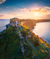 View from flying drone. Aerial spring view of Milazzo lighthouse. Gorgeous morning scene of Milazzo peninsula. Stunning sunrise on Sicily, Italy, Europe. Beauty of nature concept background.