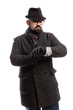 © Анна Демидова - Elegant man with a beard in a coat and hat looks at his watch. White background. Vertical.