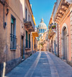 Bright spring cityscape of Ragusa town with  Duomo San Giorgio - baroque Catholic church on background. Nice morning scene of Sicily, Italy, Europe. Traveling concept background.