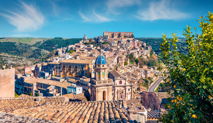 Wall Mural - Sunny spring cityscape of Ragusa town with Palazzo Cosentini and Duomo di San Giorgio church on background. Nice afternoon scene of Sicily, Italy, Europe. Traveling concept background.