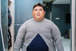 Fat Asian man wearing tight unbuttoned shirt