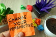 Slogan change your perspective handwritten on sticky note