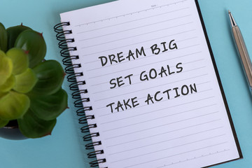 Wall Mural - Inspirational quotes text on note pad - Dream big, Set goals, Take action.