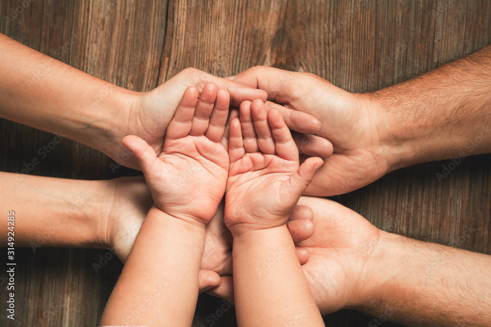 Three hands of family. Love, togetherness, happiness in family concept. - obrazy, fototapety, plakaty 