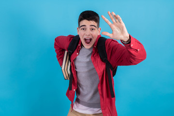 Poster - student running with books and backpack isolated on color background