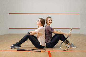 Wall Mural - Players with squash rackets sits back to back