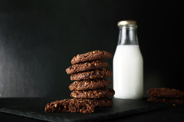 cookies and milk with black plate presentation