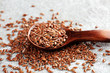 Uncooked linseed in wooden spoon, rustic style. Healthy linseed