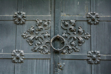 Wall Mural - Close-up of ancient vintage metal door with cast iron floral deorative ornament