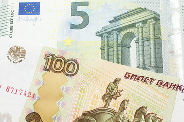 A close up image of a one hundred Russian ruble bank note close up with a five Euro bank note