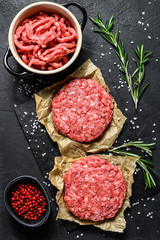 Wall Mural - Home HandMade Raw Minced Beef steak burgers. Farm organic meat. Black background. Top view