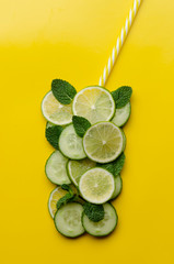 Wall Mural - Infused water on a glass. Detox water mix of cucumber, lemon, lime and mint.