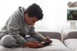 Child with portable games console. video game console for home or portable gaming. Teenager man playing game on console