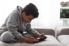 Child With Portable Games Console. Video Game Console For Home Or Portable Gaming. Teenager Man Playing Game On Console