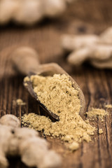 Wall Mural - Some Ginger Powder on a vintage wooden table (selective focus; close-up shot)