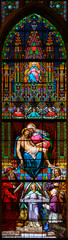 Wall Mural - Bratislava, Slovakia. 2019/11/4. Stained glass window depicting the Pieta – the Grieving Virgin Mary holding her dead Son Jesus Christ in her arms. St Martin's Cathedral, Bratislava, Slovakia.