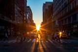 Fototapeta Nowy Jork - Crowds of diverse people walk across a busy intersection on 5th Avenue in New York City with sunlight background