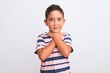 © Krakenimages.com - Beautiful kid boy wearing casual striped t-shirt standing over isolated white background shouting and suffocate because painful strangle. Health problem. Asphyxiate and suicide concept.