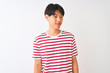 © Krakenimages.com - Young chinese man wearing casual striped t-shirt standing over isolated white background looking away to side with smile on face, natural expression. Laughing confident.