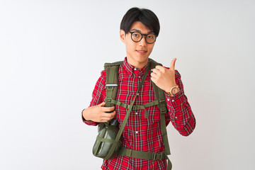 Chinese hiker man wearing backpack canteen glasses over isolated white background doing happy thumbs up gesture with hand. Approving expression looking at the camera showing success.