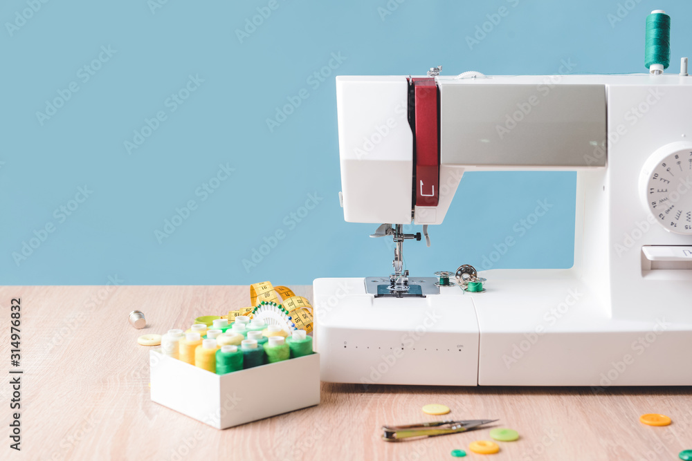 Sewing machine with supplies on table