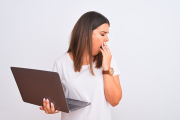 Poster - Beautiful young woman working using computer laptop over white background bored yawning tired covering mouth with hand. Restless and sleepiness.