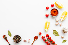 Kitchen Frame With Spices And Food - Pepper, Garlic, Cherry Tomatoes - On White Background Top-down Frame Copy Space