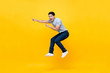 © Atstock Productions - Energetic excited young Asian man in casual clothes jumping in yellow background