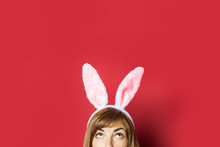 Young Beautiful Woman With Rabbit Ears On A Pink Background. Easter Concept