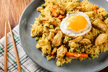 Poster - Fried rice nasi goreng with chicken egg and vegetables on a plat