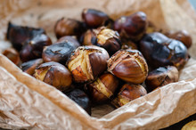 Grilled Chestnuts On The Wooden Table.